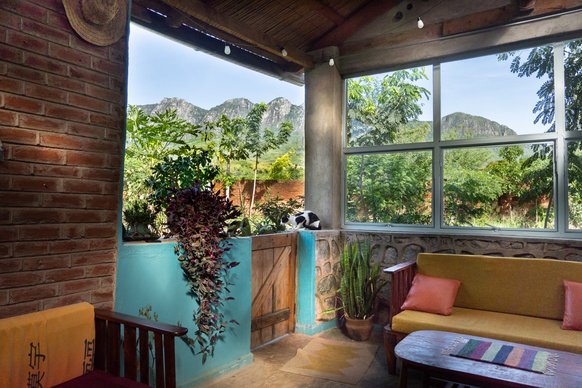 Interior view of Plateau East eco-village with mountain backdrop, Zomba, Malawi